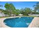 Backyard pool featuring clear blue water, with a surrounding brick patio perfect for lounging and outdoor enjoyment at 1310 Rustlewood Dr, Brandon, FL 33510