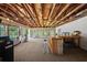 Large rec room with exposed wood ceiling, bar, seating, and access to the yard at 1310 Rustlewood Dr, Brandon, FL 33510