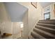 Carpeted staircase leading to the entryway with tile flooring and a bright, welcoming atmosphere at 1310 Rustlewood Dr, Brandon, FL 33510