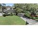 A lovely yard features mature trees and shrubs surrounding this charming two-story home at 1310 Rustlewood Dr, Brandon, FL 33510