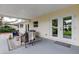 Covered patio with wicker furniture, offering a cozy outdoor space at 13344 88Th Ave, Seminole, FL 33776