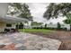 Spacious backyard featuring a large patio, green lawn, and white privacy fence, perfect for outdoor enjoyment at 13344 88Th Ave, Seminole, FL 33776