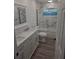 Modern bathroom with marble-look tile, double sink vanity, tub with shower, and updated fixtures at 13344 88Th Ave, Seminole, FL 33776