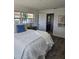 Bright bedroom features a large window, stylish decor, and an en-suite bathroom at 13344 88Th Ave, Seminole, FL 33776