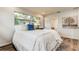 Comfortable bedroom featuring windows, a cozy rug, and an ensuite bathroom at 13344 88Th Ave, Seminole, FL 33776