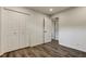 Bright bedroom featuring wood-look floors, closet with folding doors, and white trim at 13344 88Th Ave, Seminole, FL 33776