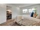 Bright bedroom with wood floors, white walls, and view to kitchen area at 13344 88Th Ave, Seminole, FL 33776