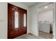 Elegant front door with decorative glass, leading to a view of the laundry area at 13344 88Th Ave, Seminole, FL 33776