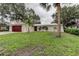 Inviting single-story home with lush lawn, dark garage door, and arched front entryway at 13344 88Th Ave, Seminole, FL 33776