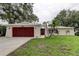 Charming single-story home features a two-car garage, well-kept lawn, and stylish front door at 13344 88Th Ave, Seminole, FL 33776