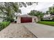 A beautiful home featuring a two-car garage with a driveway and manicured landscaping at 13344 88Th Ave, Seminole, FL 33776