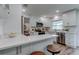Bright kitchen featuring white cabinets, stainless steel appliances, breakfast bar with seating, and wood-look flooring at 13344 88Th Ave, Seminole, FL 33776