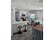 Bright kitchen features white cabinets, stainless steel appliances, quartz countertops, and a breakfast bar with seating at 13344 88Th Ave, Seminole, FL 33776