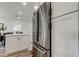 Modern kitchen boasts stainless steel refrigerator and white cabinetry with sleek hardware at 13344 88Th Ave, Seminole, FL 33776