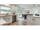 Sunlit kitchen blends seamlessly with dining area, featuring stainless steel appliances at 13344 88Th Ave, Seminole, FL 33776
