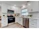 Bright kitchen featuring stainless steel appliances, white countertops, and shaker style cabinets at 13344 88Th Ave, Seminole, FL 33776
