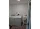 Laundry room with washer, dryer, utility sink, and a door leading to another part of the home at 13344 88Th Ave, Seminole, FL 33776