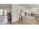 Open-concept living space with hardwood floors, leading to a dining area and sunlit spaces at 13344 88Th Ave, Seminole, FL 33776
