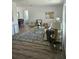Open floor plan living room with neutral decor, stylish furniture, area rug, and large windows for natural light at 13344 88Th Ave, Seminole, FL 33776