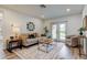 Cozy living room with natural light, stylish decor, and sliding door access to the backyard at 13344 88Th Ave, Seminole, FL 33776