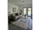 Cozy living room with comfortable seating, area rug, stylish decor, and french doors leading to the backyard at 13344 88Th Ave, Seminole, FL 33776