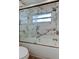 Shower stall featuring marble tile walls and glass doors at 13344 88Th Ave, Seminole, FL 33776