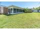 Beautiful backyard featuring an enclosed sunroom and storage shed at 14060 102Nd Ave, Largo, FL 33774