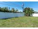 Backyard featuring a well-maintained lawn and a white vinyl privacy fence at 14060 102Nd Ave, Largo, FL 33774