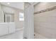 Well-lit bathroom features modern fixtures, neutral tile, a shower with curtain, and a single sink vanity at 14060 102Nd Ave, Largo, FL 33774