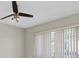 This light bedroom features a modern ceiling fan, tile floors, and ample natural light through the window at 14060 102Nd Ave, Largo, FL 33774