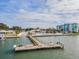 Scenic view of the waterfront with a community dock, pool, and surrounding neighborhood buildings at 14060 102Nd Ave, Largo, FL 33774