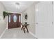 Inviting foyer features tile flooring, an elegant front door, and a decorative mirror at 14060 102Nd Ave, Largo, FL 33774
