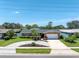 Well-maintained home featuring a circular driveway and manicured landscaping at 14060 102Nd Ave, Largo, FL 33774