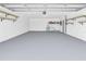 Spacious garage with epoxy flooring, shelving, and water heater at 14060 102Nd Ave, Largo, FL 33774