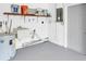Well-lit garage with sink, water heater, and storage shelves at 14060 102Nd Ave, Largo, FL 33774