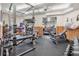 Well-equipped exercise room with weightlifting machines, free weights, mirrors, and rubber flooring at 14060 102Nd Ave, Largo, FL 33774