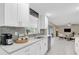 Modern kitchen with white cabinets, granite countertops, stainless steel appliances, and open layout at 14060 102Nd Ave, Largo, FL 33774