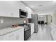 Modern kitchen features white cabinets, stainless steel appliances, and granite countertops at 14060 102Nd Ave, Largo, FL 33774