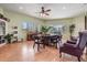 A charming library room with a piano, bookshelves, a table and chairs, and large bright windows at 14060 102Nd Ave, Largo, FL 33774