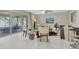 Bright and airy living room with tile flooring, modern furniture, and a screened patio view at 14060 102Nd Ave, Largo, FL 33774
