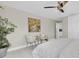 This light bedroom features tile floors, a ceiling fan, two chairs and decor on the walls at 14060 102Nd Ave, Largo, FL 33774