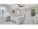 Bright and airy bedroom boasts stylish decor, a round mirror, and an ensuite bathroom at 14060 102Nd Ave, Largo, FL 33774