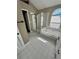 Bathroom featuring a walk-in shower and soaking tub beneath an arched window at 15101 Bald Eagle St, Tampa, FL 33625