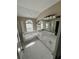 Bright bathroom with dual vanity, soaking tub, and a separate shower with a tiled surround at 15101 Bald Eagle St, Tampa, FL 33625