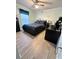 Bedroom with wood floors, dark furnishings, and a large window at 15101 Bald Eagle St, Tampa, FL 33625