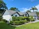 A single-story home showcasing lush landscaping and a well-maintained lawn on a clear, sunny day at 15101 Bald Eagle St, Tampa, FL 33625