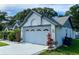 Attached two-car garage featuring a freshly painted exterior with decorative windows above the door at 15101 Bald Eagle St, Tampa, FL 33625