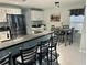 Open kitchen with stainless steel appliances and bar seating adjoining the dining area at 15101 Bald Eagle St, Tampa, FL 33625