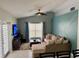 Cozy living room features a modern ceiling fan and comfortable seating with natural light from the window at 15101 Bald Eagle St, Tampa, FL 33625