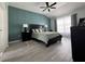 Serene main bedroom featuring a paneled accent wall, modern ceiling fan, and ample natural light at 15101 Bald Eagle St, Tampa, FL 33625